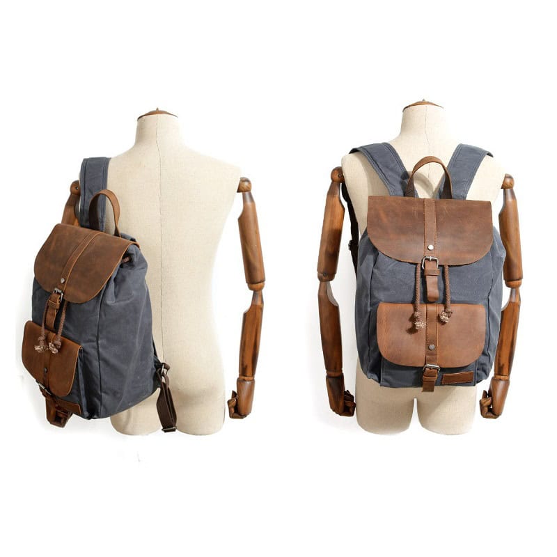Backpack with brown leather accents on a mannequin, ideal for travel and daily use, showcasing stylish and durable design.