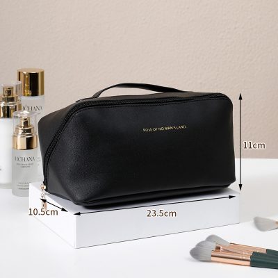 Black makeup bag with gold zipper and