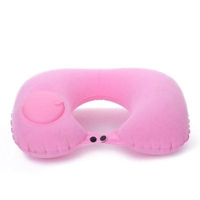 Pink inflatable travel pillow with built-in eye mask for comfort on flights and travel.