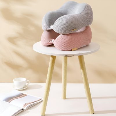 Soft nursing pillows stacked on a white round table, pastel pink and gray, ergonomic support for new mothers, Monalisa Store.