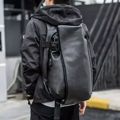 Stylish black leather backpack on a person wearing a black jacket, perfect for travel or daily use, combining functionality with a modern look.