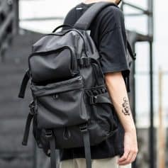Black tactical backpack with multiple compartments and adjustable straps for travel and outdoor activities. Durable and spacious, perfect for carrying essentials on the go.