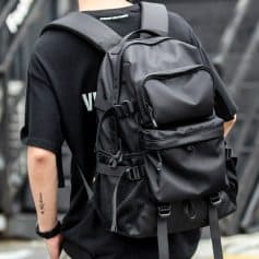 Black tactical backpack with multiple compartments, adjustable straps, and breathable mesh pockets for travel, outdoor adventures, or daily use. Durable and spacious for all your essentials.