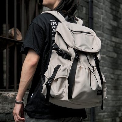 Spacious beige backpack with multiple compartments and adjustable straps, perfect for travel or daily essentials, emphasizing stylish and functional men's outdoor accessories.