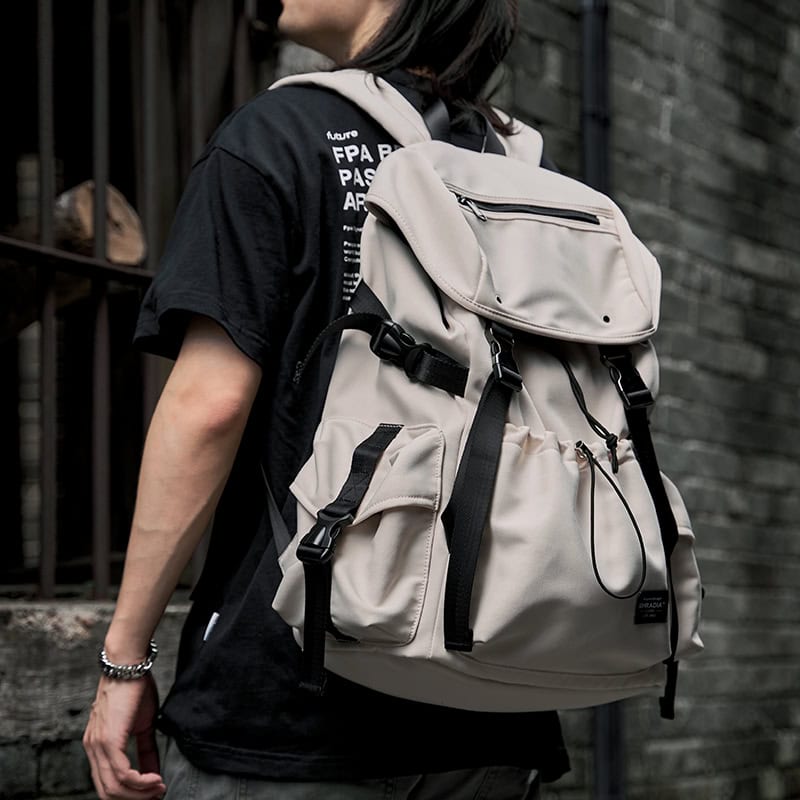 Spacious beige backpack with multiple compartments and adjustable straps, perfect for travel or daily essentials, emphasizing stylish and functional men's outdoor accessories.