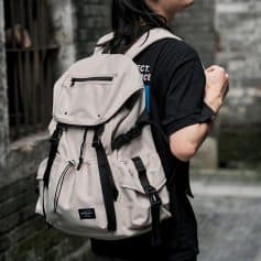 Durable beige backpack with multiple compartments, ideal for travel and daily use, featuring adjustable straps, waterproof fabric, and convenient storage pockets for essentials.