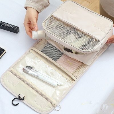Reusable travel toiletry bag organizer with compartments for toiletries and grooming essentials. Compact and versatile storage solution for cosmetics, skincare, and personal care items. Ideal for travel or daily use.