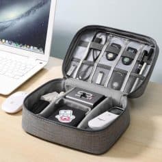 Portable electronic accessories organizer in gray with compartments and elastic straps, designed for tech gadgets, chargers, and cables at Monalisa Store.