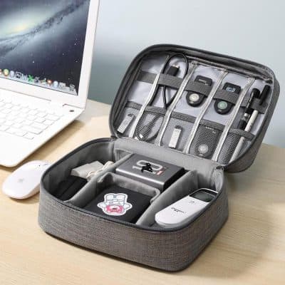 Portable electronic accessories organizer in gray with compartments and elastic straps, designed for tech gadgets, chargers, and cables at Monalisa Store.