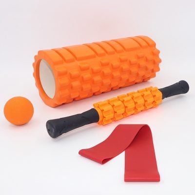 Foam roller massage stick with red resistance band and ball, physical therapy and fitness equipment for muscle recovery and pain relief.