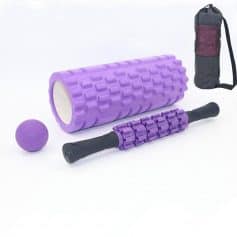 Foam roller with textured surface, massage ball, and portable carrying bag for muscle recovery and physical therapy exercises.