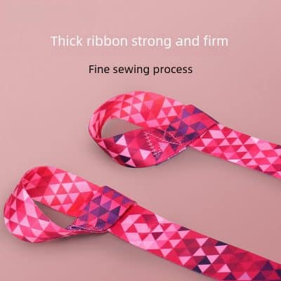 Bright pink and red ribbon with geometric triangular patterns for sewing and crafting projects, featuring a thick, strong, and firm design with fine sewing quality.