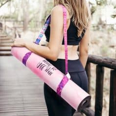 Yoga mat carrier bag with motivational quote, worn by a woman outdoors, perfect for fitness and yoga enthusiasts. Stylish, lightweight, and functional accessory for gym, yoga, or outdoor workouts.