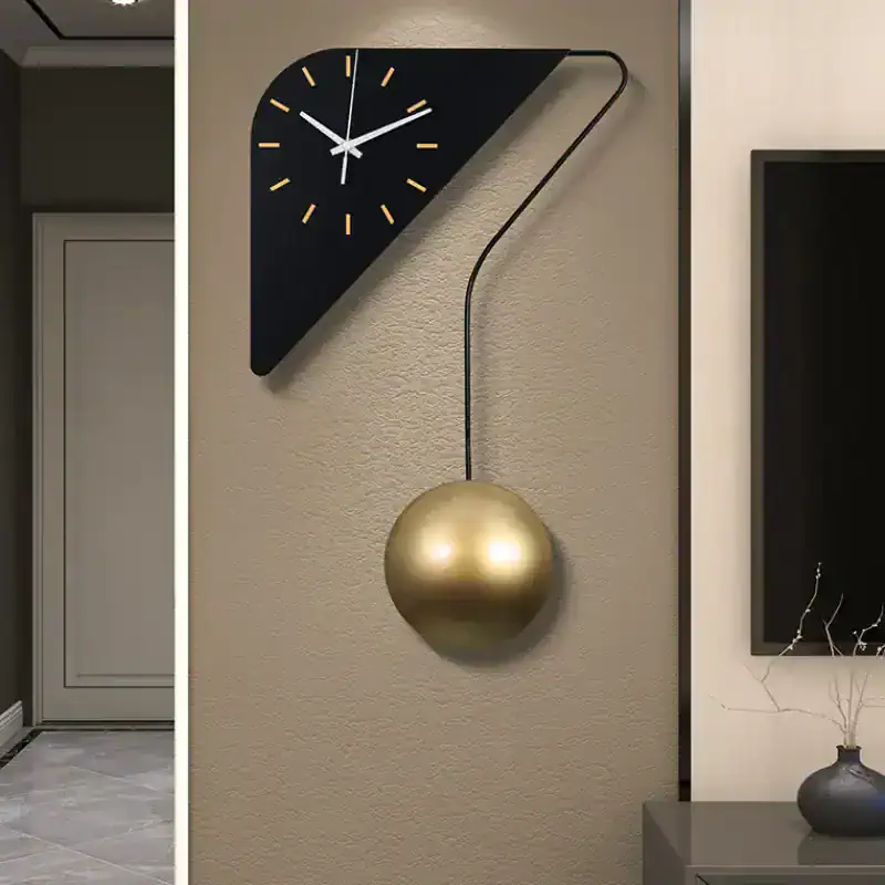 Contemporary wall clock with geometric black triangle and gold pendulum, perfect for modern interior decor. Stylish and functional decor piece for living rooms or offices.
