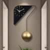 Contemporary modern wall clock with a sleek black triangular design and gold pendulum, perfect for stylish home or office decor.