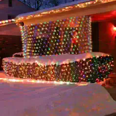 Colorful outdoor Christmas light display on a snow-covered patio at Monalisa Store, perfect for adding festive atmosphere and attracting customers during the holiday season.