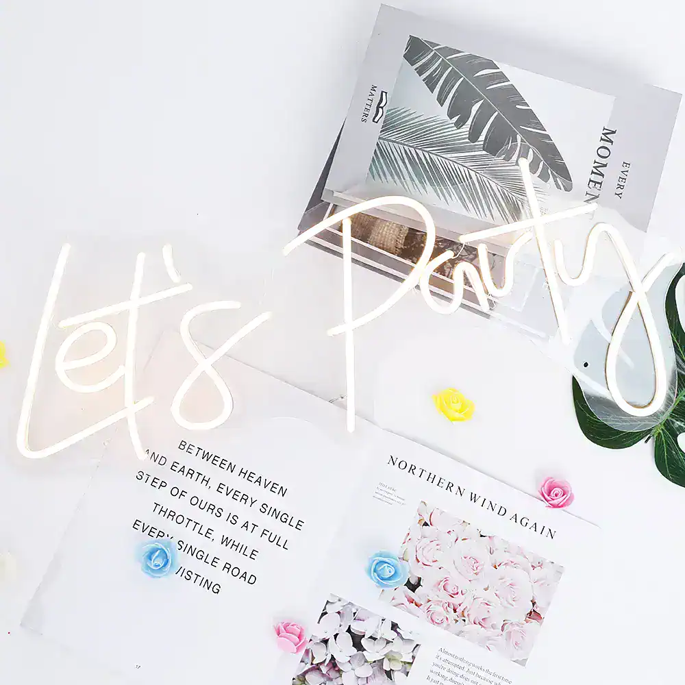 Neon "Let's Dream" sign with floral decor, modern aesthetic at Monalisa Store, emphasizing elegance and style for opt-focused branding.