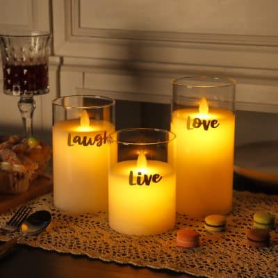Relaxing romantic candles with the words "Live," "Laugh," and "Love" illuminated in a cozy setting, perfect for home decor or special occasions.