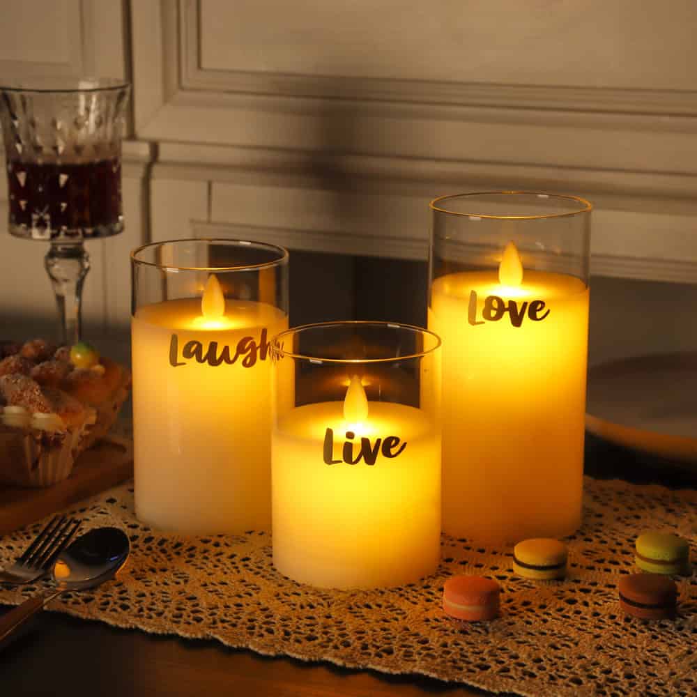 Relaxing romantic candles with the words "Live," "Laugh," and "Love" illuminated in a cozy setting, perfect for home decor or special occasions.