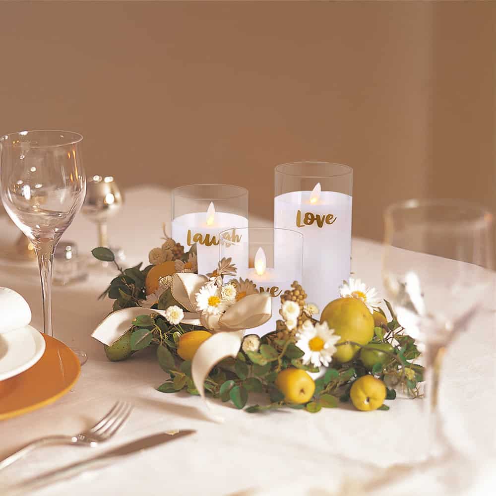 Elegant wedding table centerpiece with candles, fresh flowers, and green apples, perfect for romantic celebrations and special occasions.