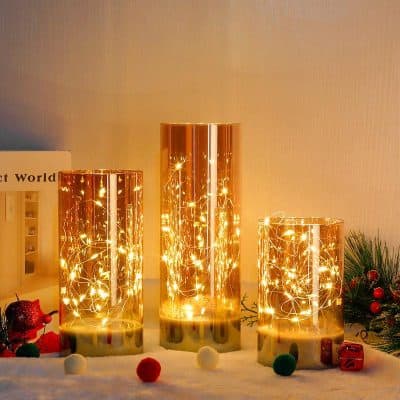 Shiny gold decorative candle holders with fairy lights, festive holiday decor, ideal for special occasions and gift sets from Monalisa Medical Store.