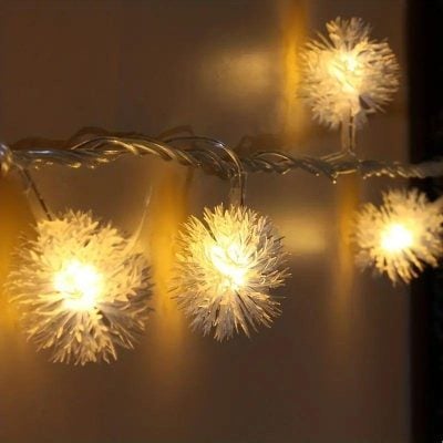 Cute pinecone string lights illuminated for cozy interior decor, perfect for enhancing ambiance in living rooms and bedrooms.