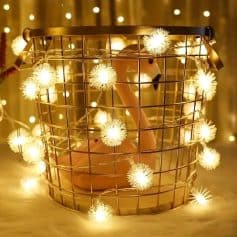 Wire basket with warm LED fairy lights and a pink flamingo decoration, creating a cozy and decorative ambiance perfect for home decor or special events.
