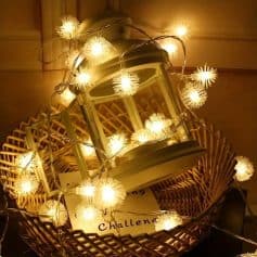 Fairy string lights with lantern in wicker basket, holiday decorative lighting, cozy ambient lighting for bedroom or living room, perfect for festive decor or outdoor settings.