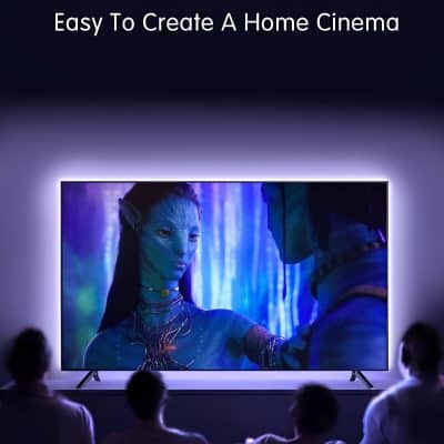 Holographic projection of an alien character with blue skin and intricate jewelry displayed on a large LED screen, demonstrating advanced home cinema options.