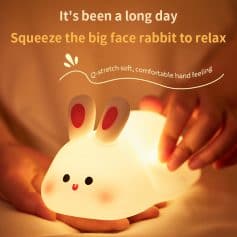 Squeezing a cute bunny-shaped lamp for stress relief with soft, comfortable hand feeling, perfect for relaxation and cozy ambiance.