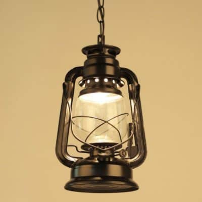 Antique vintage oil lantern hanging from a chain, used for outdoor camping or emergency lighting, with a glass chimney and metal frame.