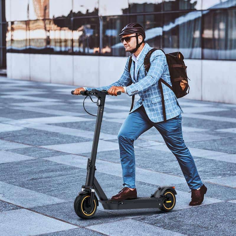 Electric scooter for commuting with stylish rider in business attire on urban sidewalk, modern transportation, eco-friendly city travel, Monalisa Store opt, stylish, urban transportation, eco-friendly, city commute.