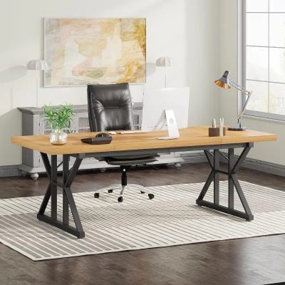 Modern office desk with a wooden top, black metal legs, and ergonomic black swivel chair in a bright, contemporary workspace with natural light and stylish decor.
