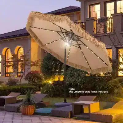 Elegant outdoor patio umbrella with string lights providing ambiance in a luxurious backyard setting. Perfect for outdoor relaxation areas at a home or resort.