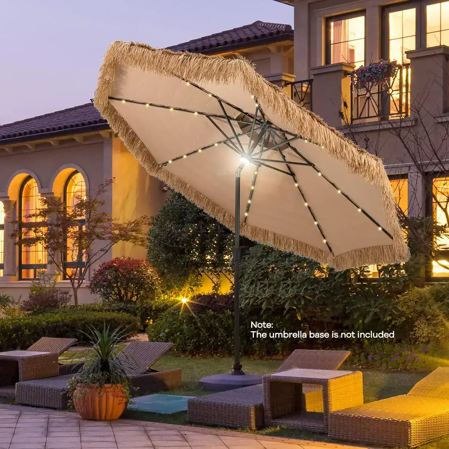 Elegant outdoor patio umbrella with string lights providing ambiance in a luxurious backyard setting. Perfect for outdoor relaxation areas at a home or resort.