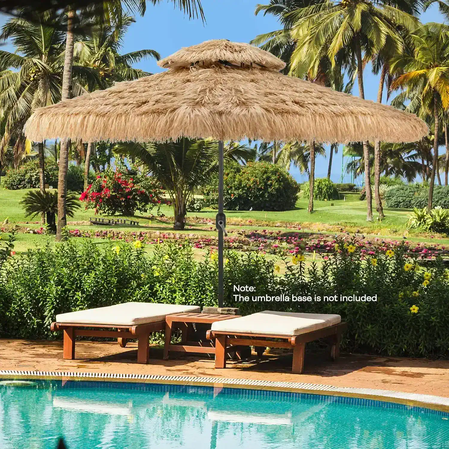 Relaxing poolside scene with an outdoor thatched umbrella, wooden sun loungers, and lush tropical landscaping perfect for resort leisure and vacation relaxation.