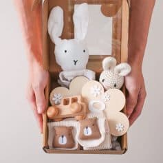 Soft bunny plush toy and wooden baby teether gift set for infants, eco-friendly natural wood accessories, and adorable bear socks ideal for baby shower presents.
