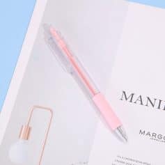 Pink gel pen on white paper with black text about jewelry and fashion industry.