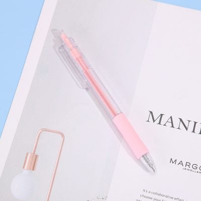 Pink gel pen on white paper with black text about jewelry and fashion industry.