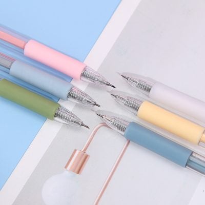 Silky pastel-colored pens on white and blue paper, stationery supplies for creative writing or note-taking, aesthetic office accessories, Monalisa Medical store.