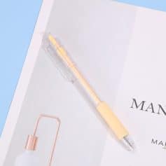 Bright yellow gel pen on fashion magazine page, minimalistic office desk scene, clean aesthetic, stylish stationery, artistic workspace, Monalisa Medical store, professional optical products, quality eye care supplies.