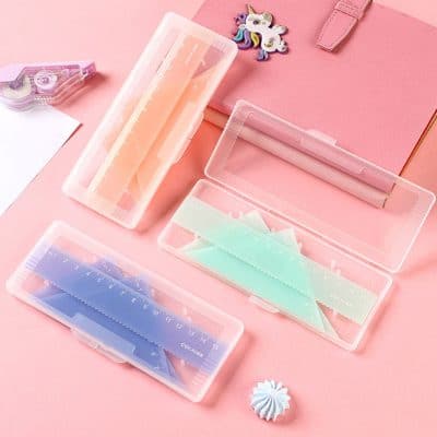 Colorful plastic rulers and cosmetic storage cases on pink background, ideal for organizing beauty tools and accessories, perfect for Monalisa Store's beauty and lifestyle essentials collection.