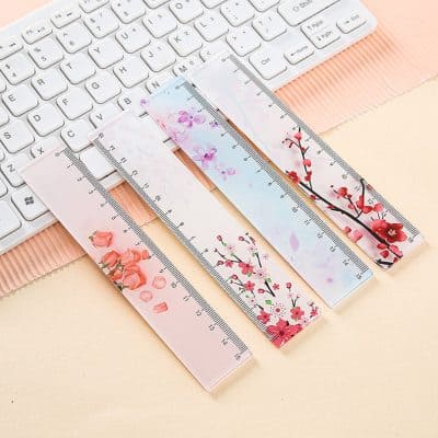Delicate floral-themed transparent rulers placed on a pastel-colored desk beside a white keyboard, perfect for precise measurement in beauty, fashion, or stationery projects.