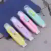 Bright pastel correction tape dispensers in yellow, purple, pink, and blue with whimsical cloud designs, perfect for school or office use.