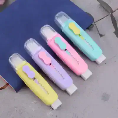 Bright pastel correction tape dispensers in yellow, purple, pink, and blue with whimsical cloud designs, perfect for school or office use.