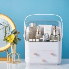 A modern, organized cosmetic storage box with skincare products on a tabletop, against a blue background, highlighting skincare essentials, beauty, and hygiene.