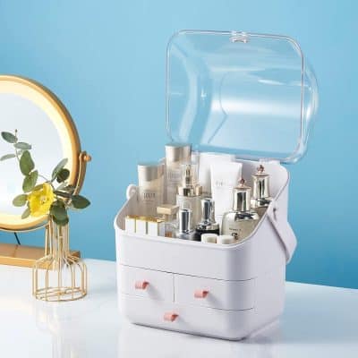 Compact beauty storage case with skincare products, cosmetics, and serums for skincare routine organized with drawers and a transparent lid.