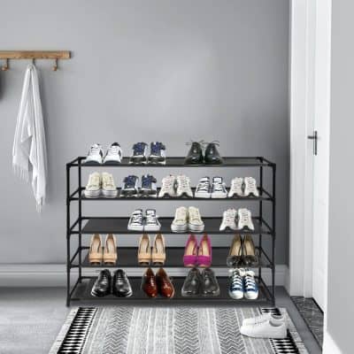 Modern shoe display with various stylish sneakers and formal shoes in a minimalistic retail environment.