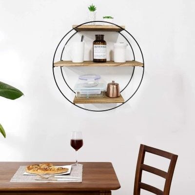 A stylish round wall shelf showcasing kitchen items, decorative plants, and storage jars, perfect for adding functional decor to your living space.
