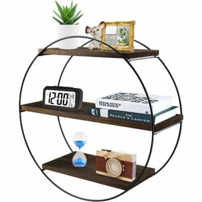 A stylish round wall shelf displaying a digital clock, decorative camera, books, an hourglass, and figurines, ideal for home decor, office organization, and modern interior design.
